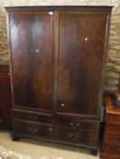 An Edwardian mahogany two door wardrobe compactum with fitted upper section over two short and one