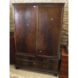 An Edwardian mahogany two door wardrobe compactum with fitted upper section over two short and one