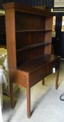 A mahogany dresser with open shelves above two drawers,