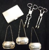 A silver cigarette case, two silver sugar tongs, three silver bottle labels inscribed "Sherry",