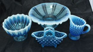 A collection of Fentons blue glass Uranium glass wares to include vases, baskets, bowls,