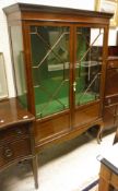 An Edwardian mahogany and inlaid display cabinet on cabriole legs to pad feet