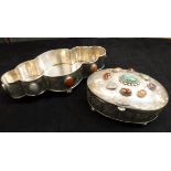 A silver and white metal shaped dish with stone medallion decorated raised on four ball feet
