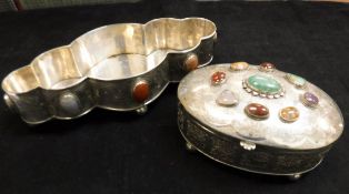 A silver and white metal shaped dish with stone medallion decorated raised on four ball feet