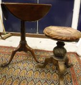 A 19th Century mahogany triple drop-leaf pedestal tea table on cabriole supports to pad feet,