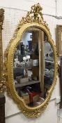A 19th Century shaped wall mirror with giltwood frame and scrolling rococo style top,