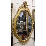 A 19th Century shaped wall mirror with giltwood frame and scrolling rococo style top,