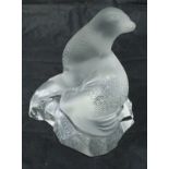 A modern Lalique figure of a seated sea lion upon a rock,