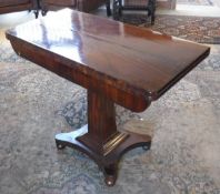 A 19th Century mahogany tea table, raised on square sectioned tapering column to quatrefoil base,