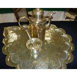 A shaped brass and engraved tray in Indian manner,