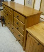 A 20th Century American oak chest with central cupboard door flanked by three small drawers over a