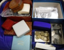 A white simulated leather vanity case containing various Coins of the Realm and foreign coinage