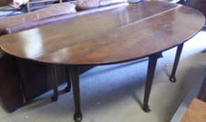 A modern oak drop-leaf wake table of typical form in the 18th Century manner raised on turned