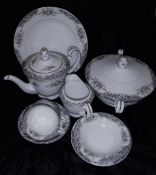 A Noritake part dinner and tea service decorated with floral sprays on a cream ground to consist of