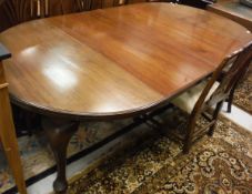 An Edwardian mahogany D-end dining table with two extra leaves and moulded edge raised on cabriole
