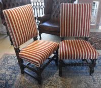 A pair of oak framed hall chairs in red and yellow striped upholstery, with barley twist stretcher,