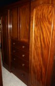A Victorian mahogany wardrobe compactum with two central cupboard doors over four drawers,