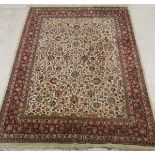 A Persian carpet, the central panel with all-over floral and bird decoration on a cream ground,