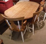 A modern pine kitchen table of rounded rectangular form,
