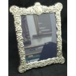 A modern embossed Carrs silver photograph frame in the Victorian taste CONDITION REPORTS