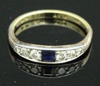 A dress ring, the yellow band marked "18CT PLAT" set with central sapphire,