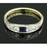 A dress ring, the yellow band marked "18CT PLAT" set with central sapphire,