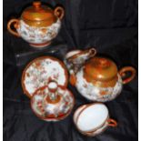 A Japanese satsuma ware part tea wares to include two teapots, twelve teacups and saucers,