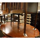 A mahogany oval dining table, a nest of three oak coffee tables,
