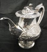 A Georgian silver teapot with later embossed decoration (London 1826 by Thomas Wilkes Baker),