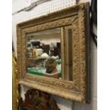 A rectangular wall mirror in a moulded frame