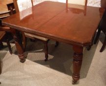 A Victorian mahogany rectangular extending dining table on turned,