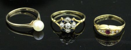A yellow metal dress ring with five central diamonds,