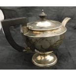 An early 20th Century silver teapot with ebony finial and handle inscribed "R.H.H. H.S.H.