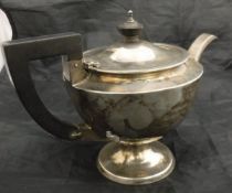 An early 20th Century silver teapot with ebony finial and handle inscribed "R.H.H. H.S.H.