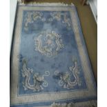 A Chinese superwash rug, the central panel set with dragons on a pale blue ground,