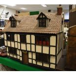 A mock Tudor dolls' house and a modern MDF Georgian style dolls' house,