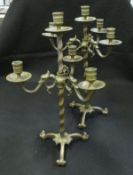 A pair of patinated bronze adjustable candelabra in the Arts & Crafts taste,