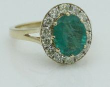 An emerald and diamond 18 carat gold ring