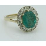 An emerald and diamond 18 carat gold ring