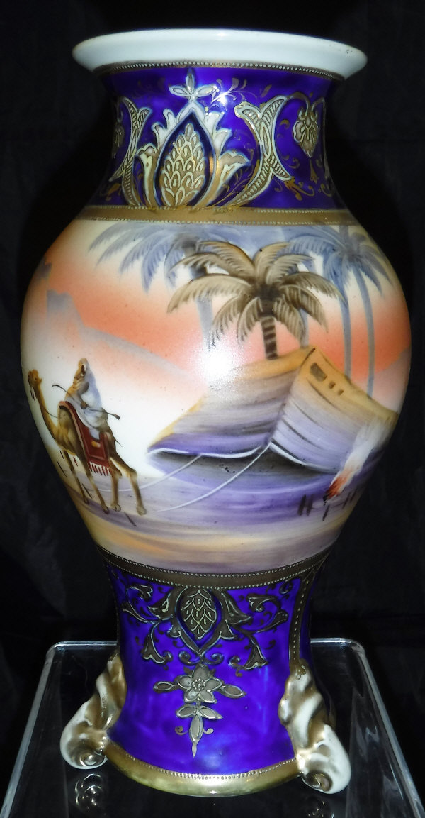 A Noritake baluster shaped vase decorated with camel and tent with pyramid in background,