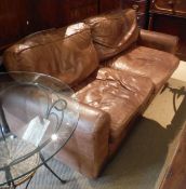 A brown leather upholstered sofa,