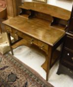 An Edwardian mahogany writing table with raised super structure over three drawers on square