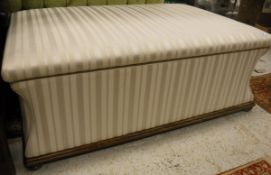 A waisted rectangular box ottoman in cream striped upholstery and beech frame