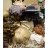 A box of assorted bisque-headed dolls in assorted dress