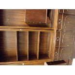 A large reproduction mahogany bookcase cabinet consisting of two central sections of shelves above