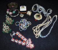 A large quantity of assorted costume jewellery to include bangles, bracelets,