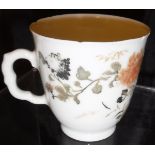 A Chinese export porcelain cup decorated with flowers on a white ground,