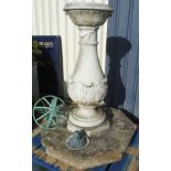 A natural stone pedestal with acanthus decoration to base raised on octagonal foot with armillary