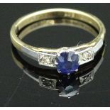 An 18 carat gold dress ring set with central sapphire and two chip diamonds, total approx 2.