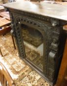 A Victorian carved oak Gothic revival side cabinet with single glazed door and figural and